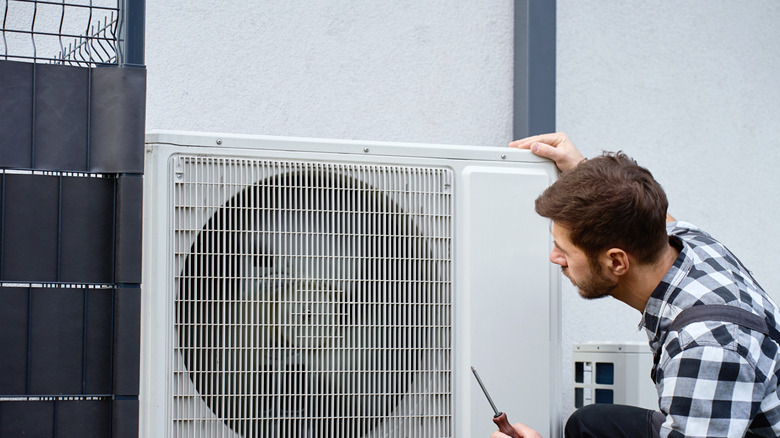 man repairing air conditioner