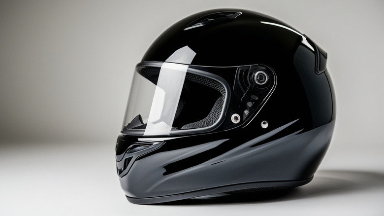 A black motorcycle helmet in a white background