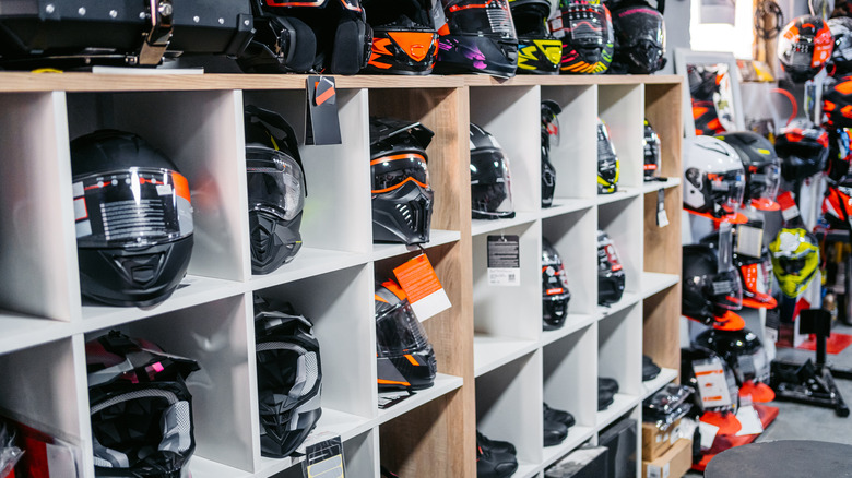Motorcycle helmets on shelves in a shop