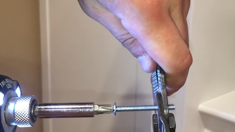 a person using the bolt cutter feature on a wire stripper