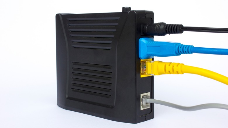 Multiple cables attached to black modem