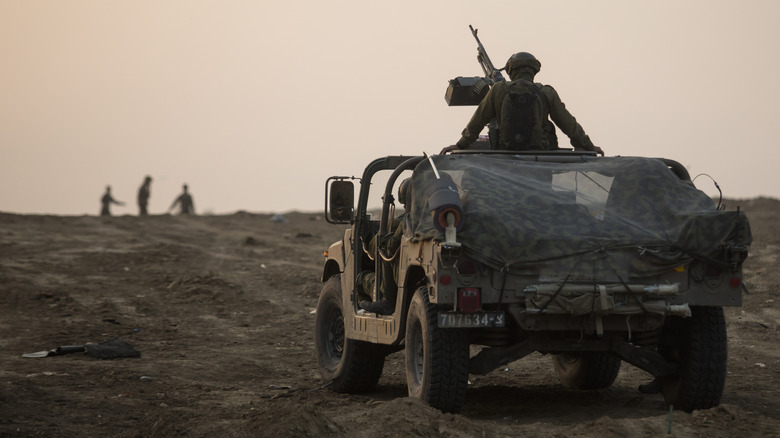 Two men sitting in a Humvee