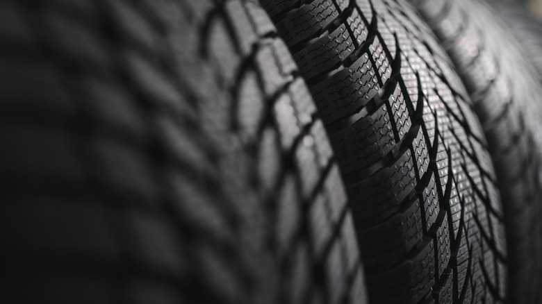 Close up of the treads of several tires.