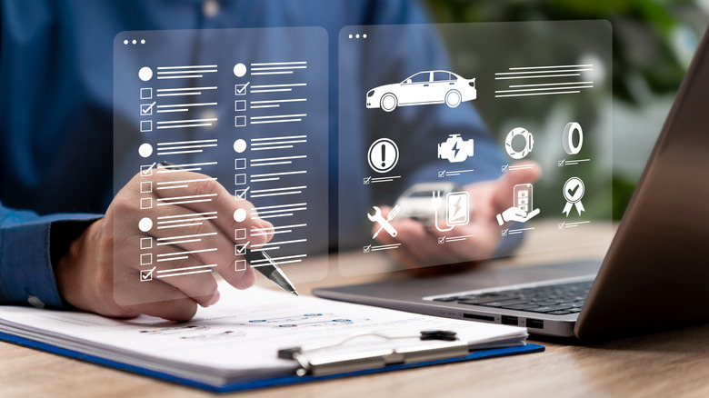 A service technician going through the car maintenance checklist