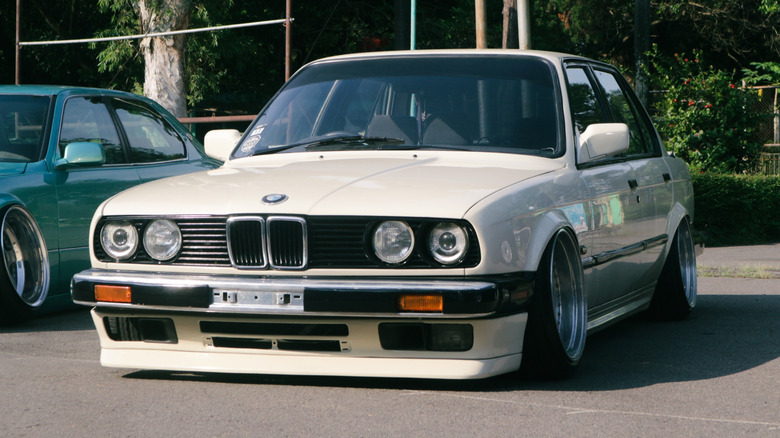 A modified white BMW E30 car for sale