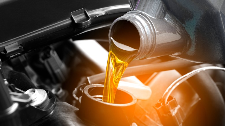 pouring fresh engine oil in