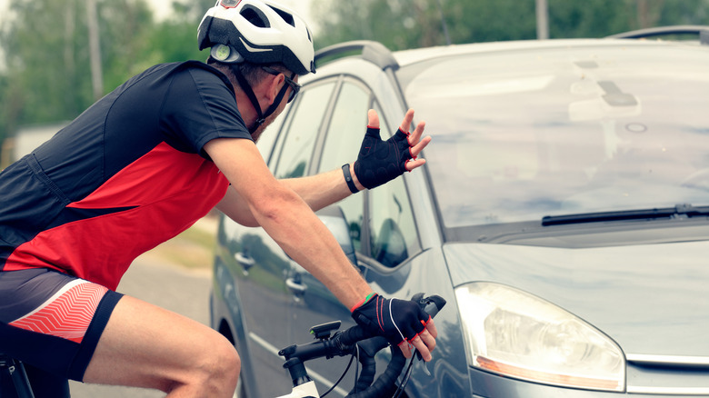 A car and a cyclist fighting over right of way