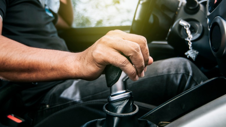 Hand on car stick shift
