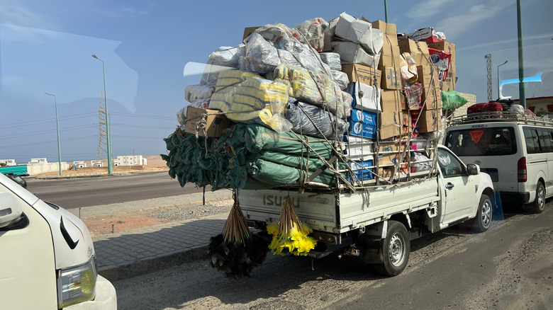 A pickup truck overloaded with items