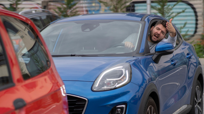 An impatient driver yelling at the car in front of them