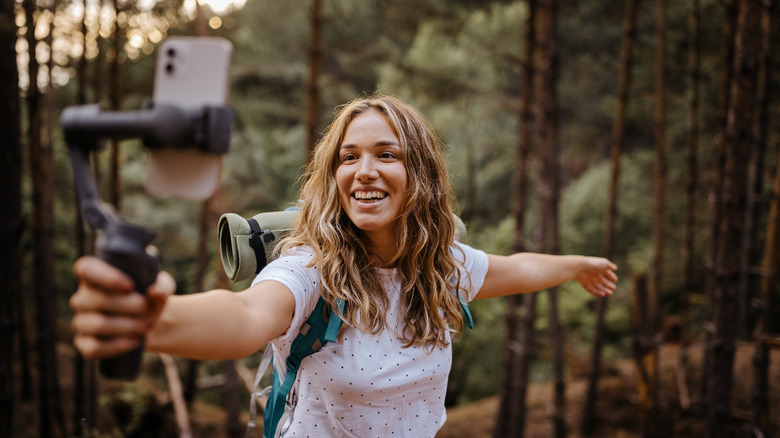 Woman holding iPhone taking a selfie