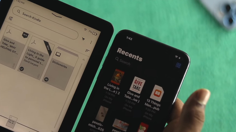A person transferring books from their phone to their Kindle