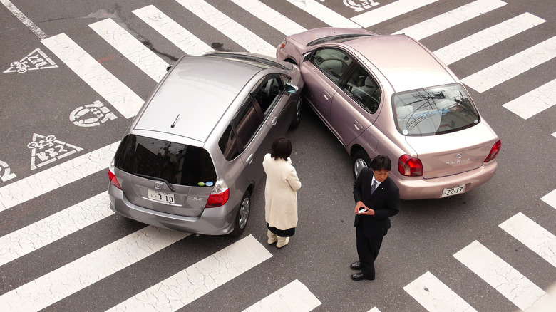 A fender bender between an SUV and a sedan in an intersection in Japan