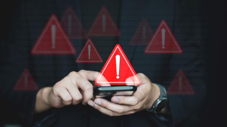 Emergency warning sign while using an app on a phone by a person