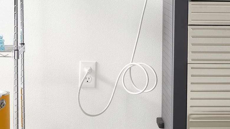 A long cord connected to an outlet.