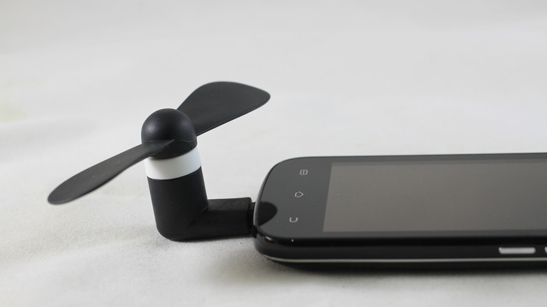 mini USB fan plugged into a phone's USB port