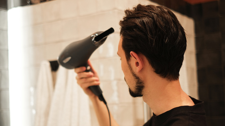 Man using a hairdryer