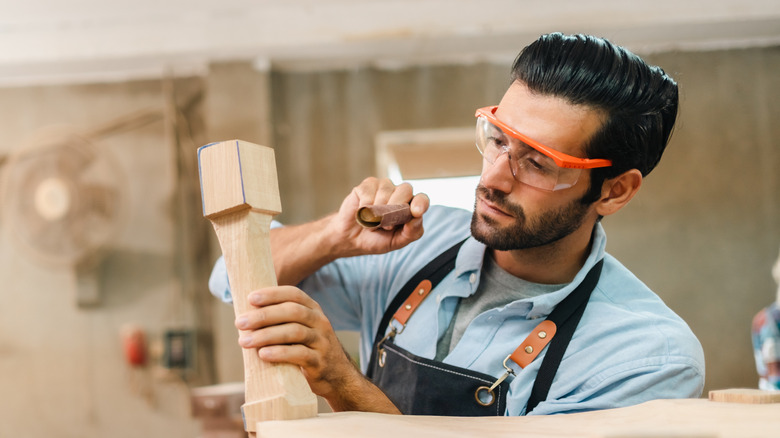 Person sanding table leg
