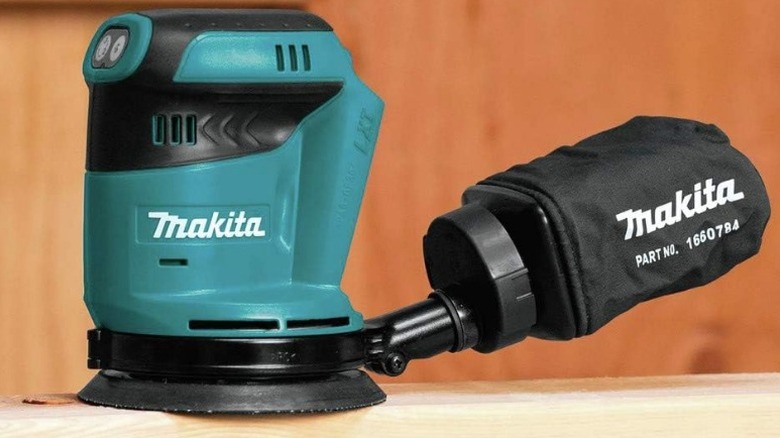 Makita sander sitting on wood