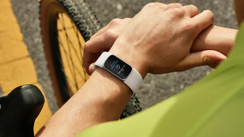 A Fitbit Charge on a person's wrist