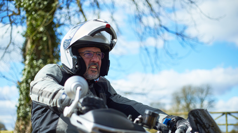 man wearing glasses riding motorcycle