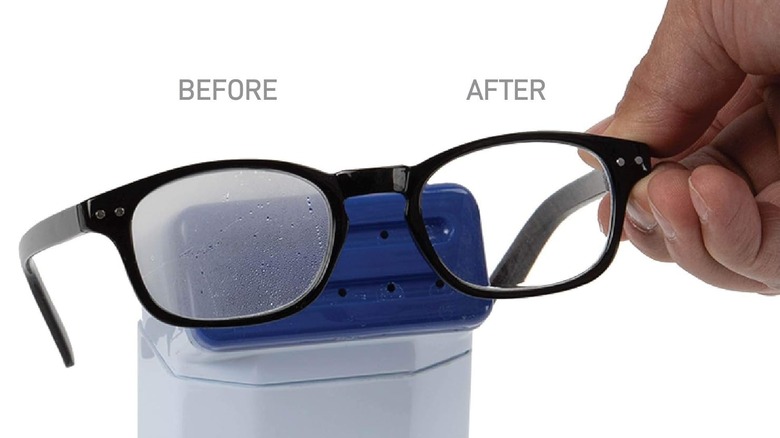person holding glasses with anti-fog