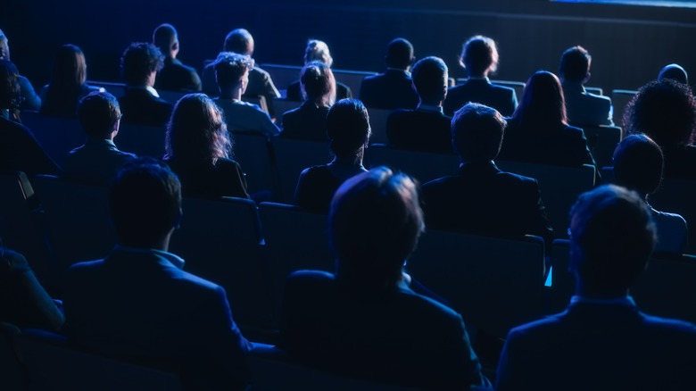 audience in chairs from behind