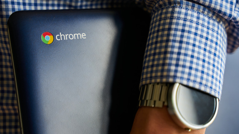 man holding a Chromebook