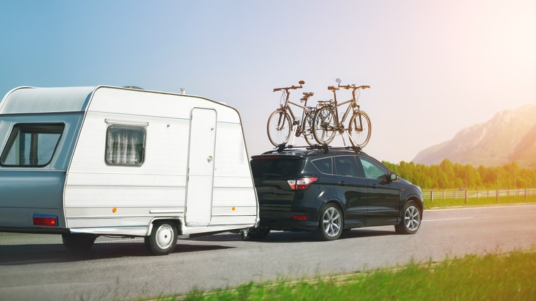 A small SUV towing a camper