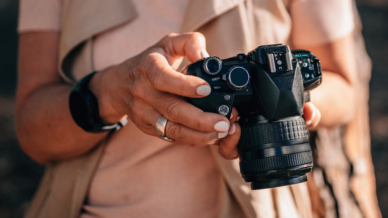 person holding DSLR camera