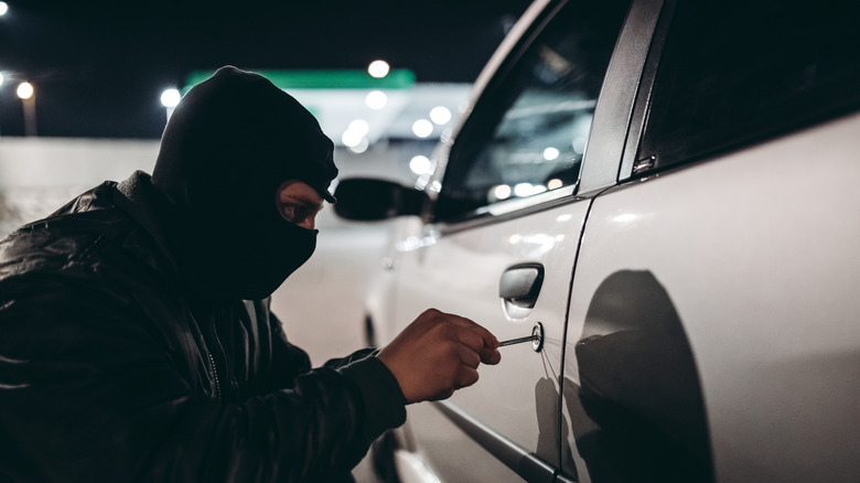 man trying to break into a car