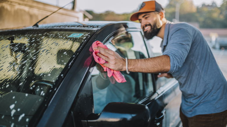 A person washing their car