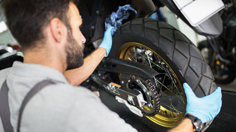 Man replacing motorcycle tires