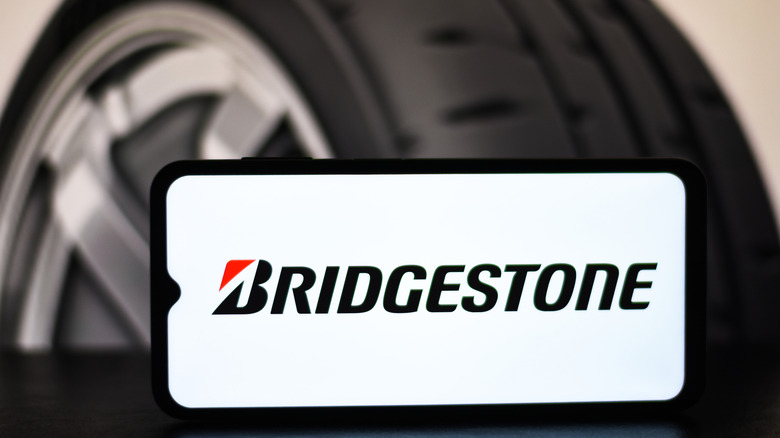 Bridgestone logo on a smartphone with a tire in background