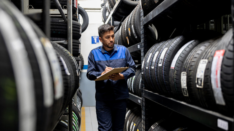 Tire shop worker checking stock