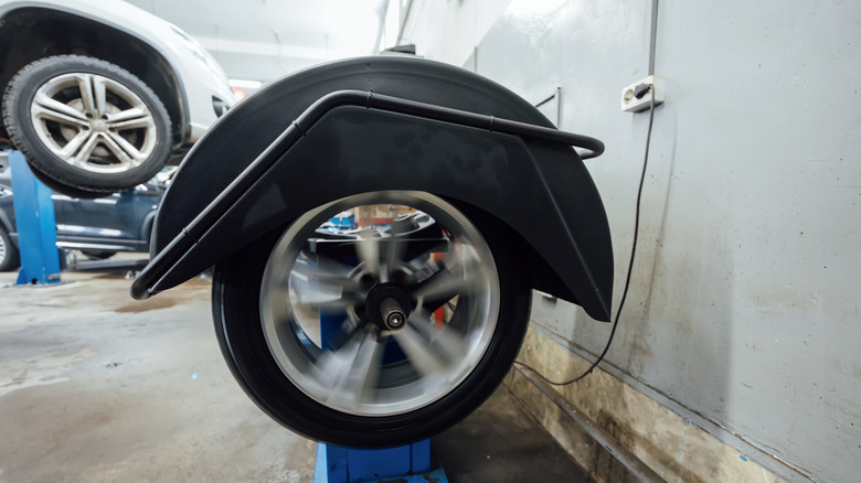 A wheel balancing machine testing a wheel.