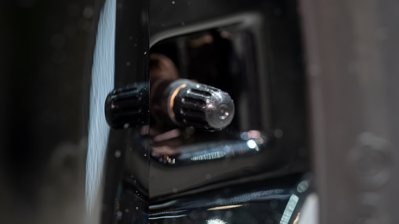 A valve stem on a car tire.