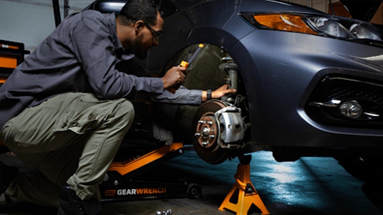 Mechanic using Gearwrench tools