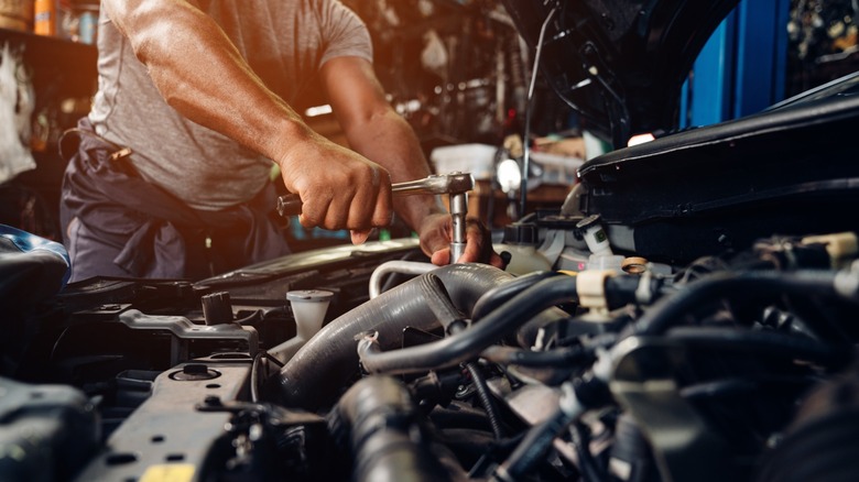 Mechanic working on car engine