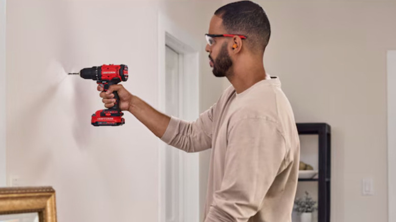 Craftsman drill being used on wall