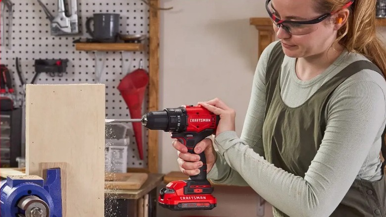 A person using Craftsman 20V Drill on board