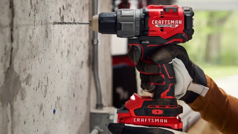 Person using Craftsman 20V Drill on cement
