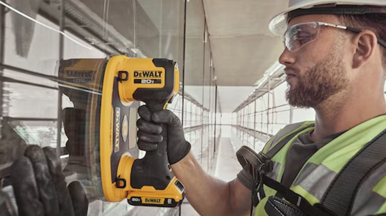 Worker using 20V Max Grabo Lifter on glass