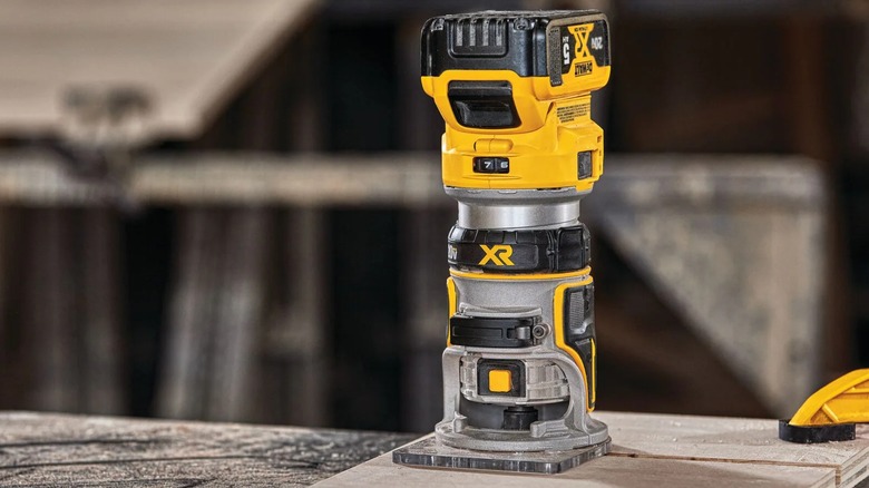 A DeWalt router on a piece of wood.
