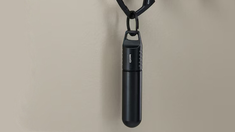 OTR Storage Pod hanging off of a wall mounted keyring hook.