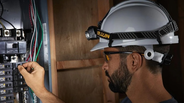 Braun 700 Lumen Adjustable Rechargeable LED Headlamp used in fixing electrical panel