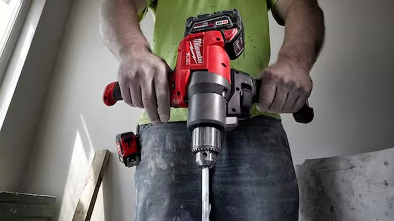 Milwaukee M18 Fuel Mud Mixer with 180-degree Handle in use