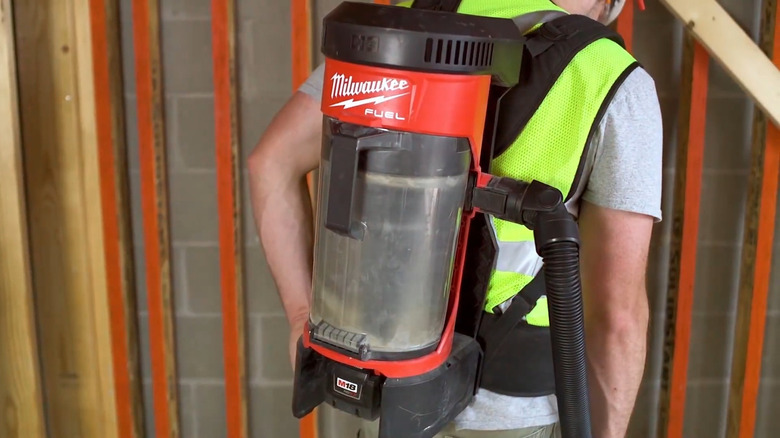 Milwaukee backpack vacuum worn by worker