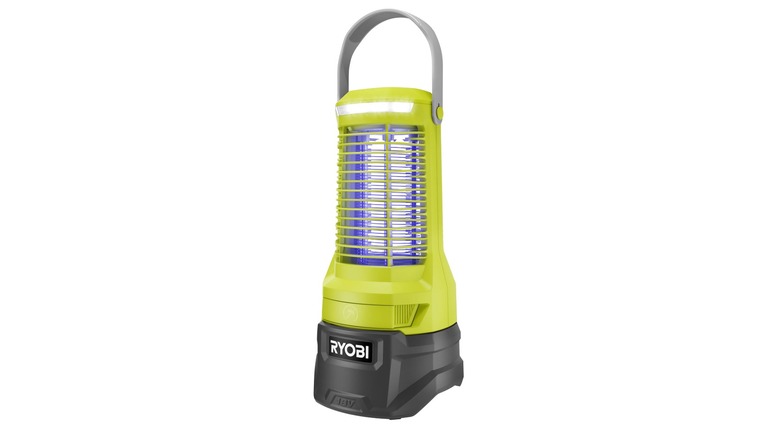 person tapping top of bug zapper