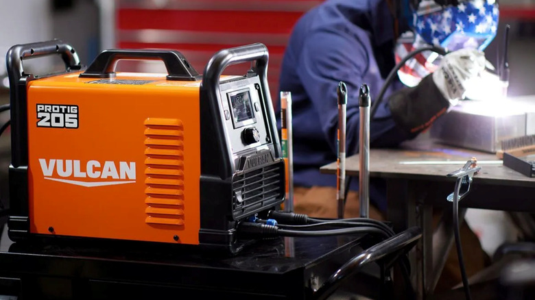 Vulcan welder with worker in background